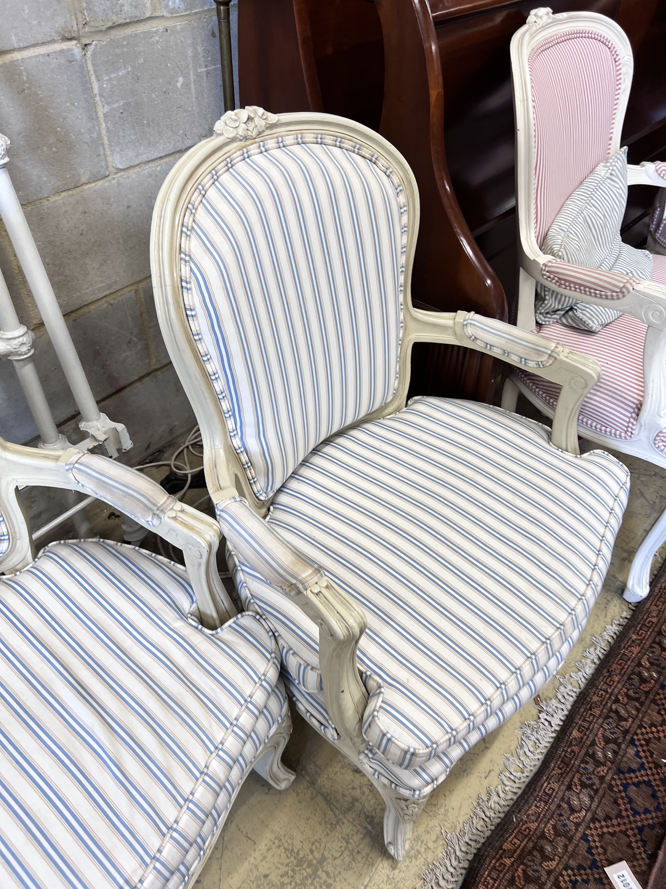 Two pairs of cream painted Louis XVI style fauteuil, heights 95cm and 91cm